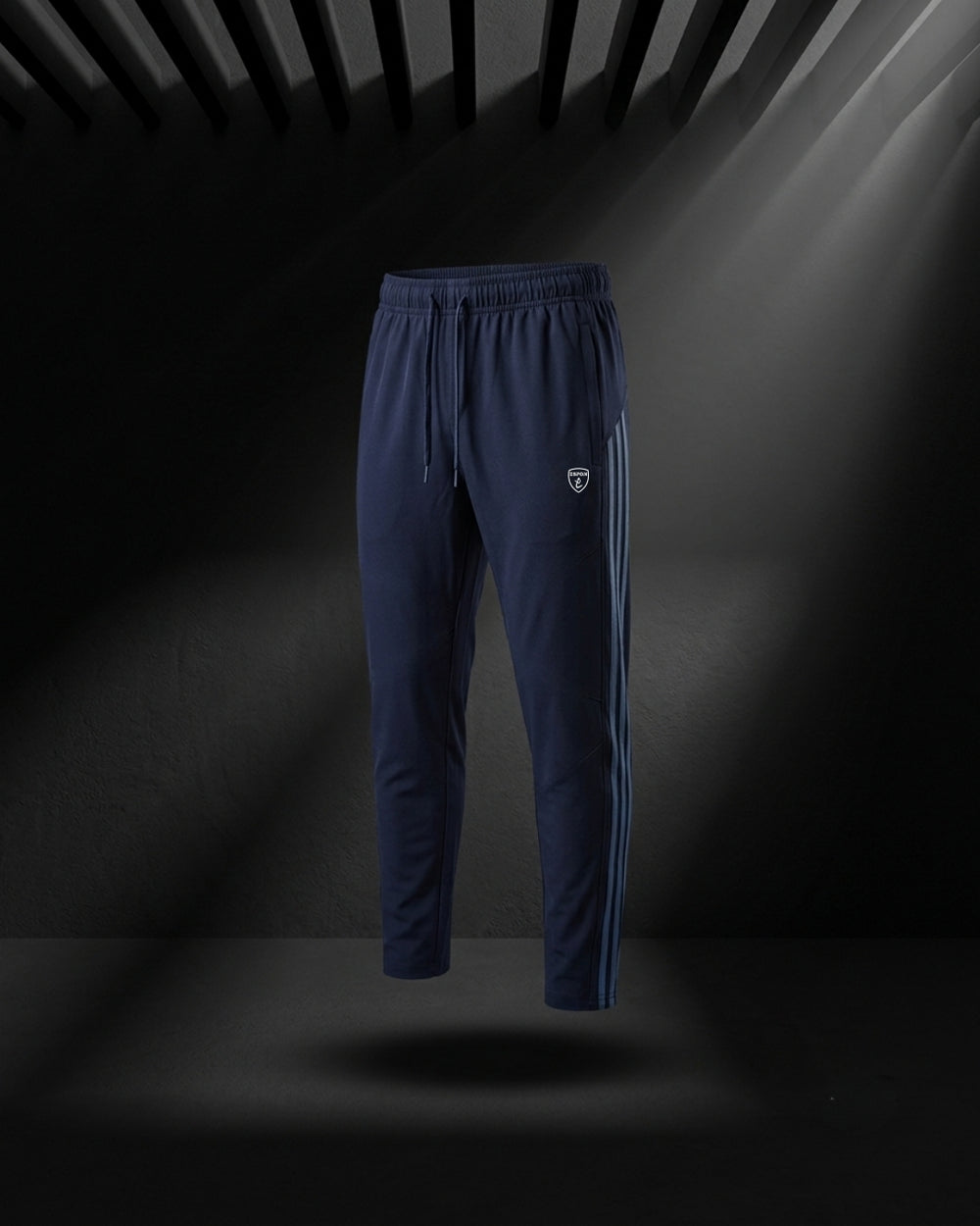 "Dark blue slim fit track pants with side stripe and elastic waist."